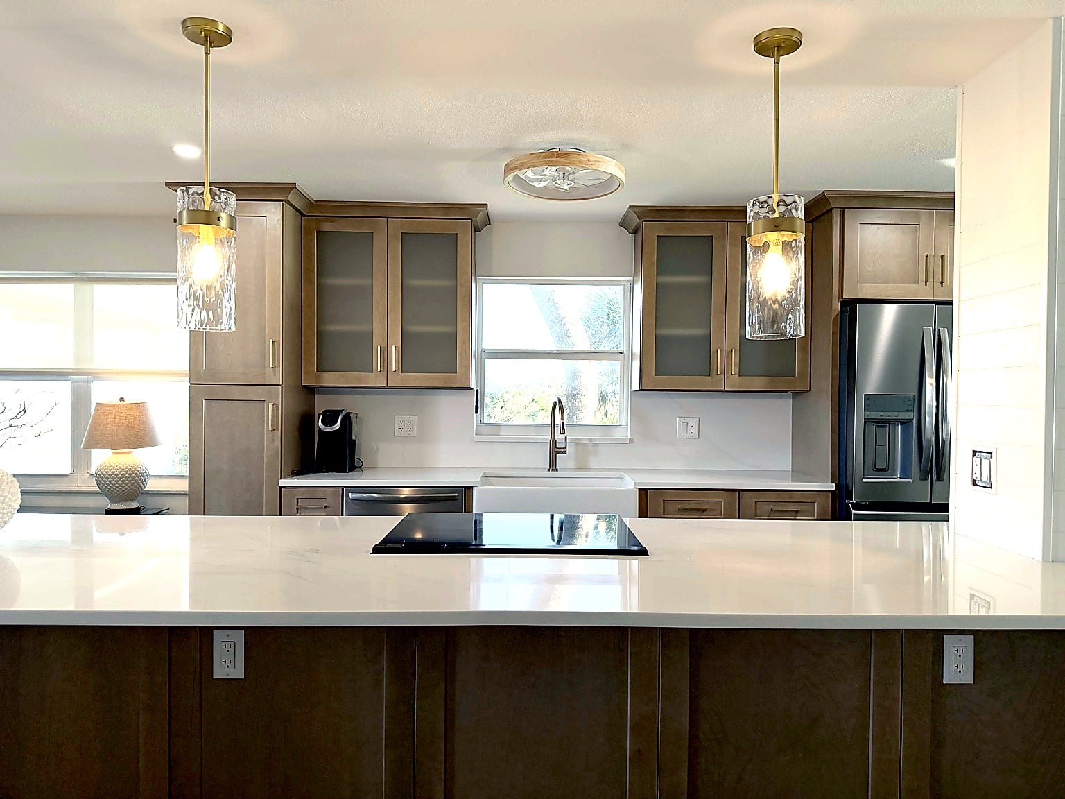 Stone surfaces, backsplash, fixtures, and hardware that define the room. — iHome Built