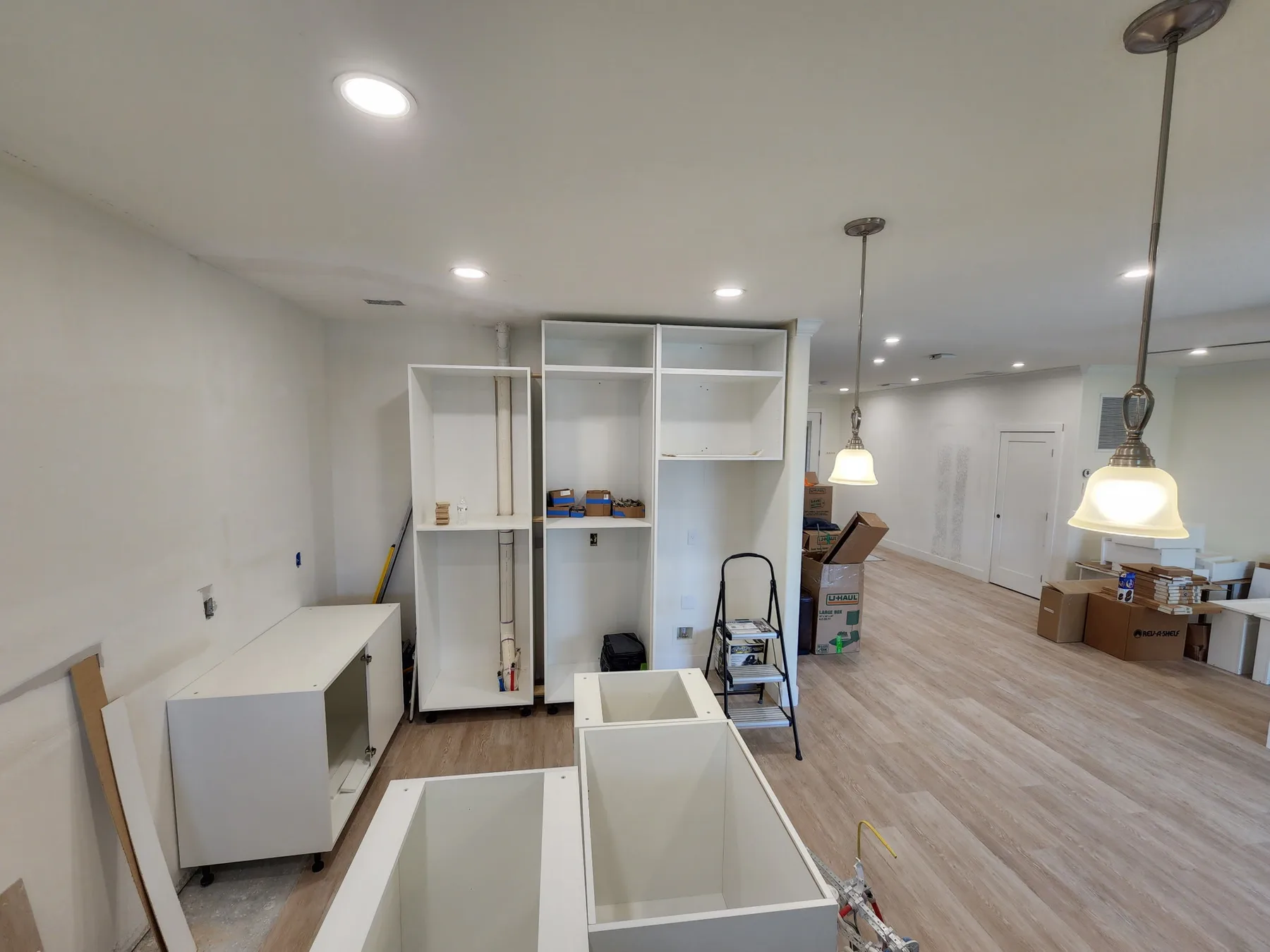 Sarasota kitchen replacement in progress with white cabinet boxes, open floor, and recessed lighting