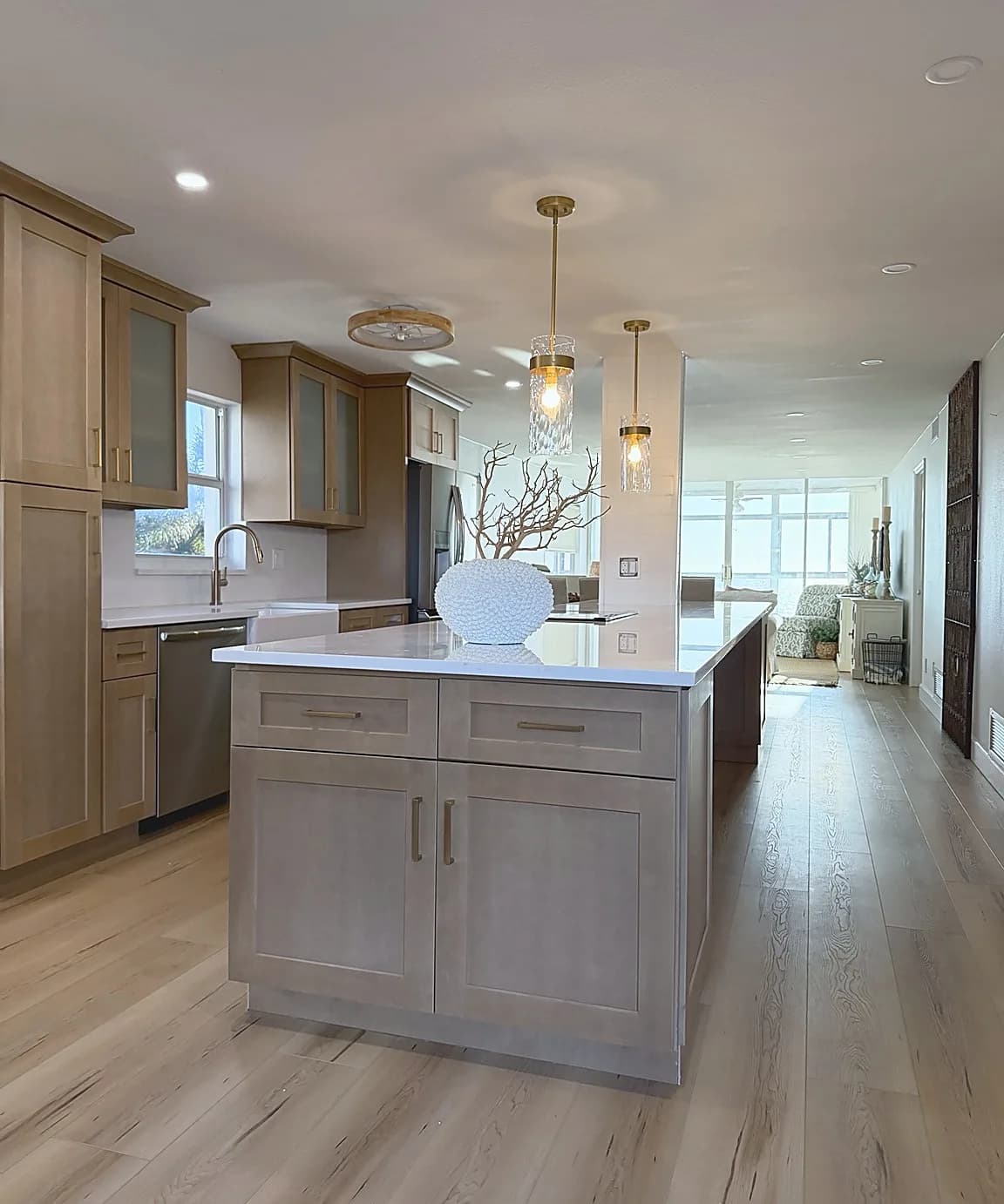 Venice-area kitchen remodel finished island with cabinet hardware, countertop, pendant lights, and connected living area