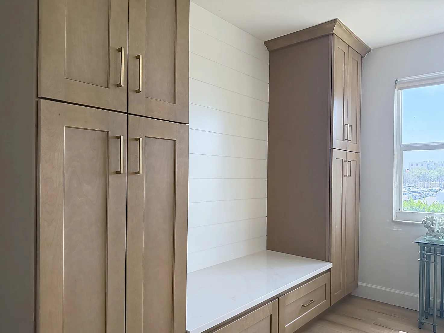 Venice-area kitchen remodel storage wall with tall cabinetry, countertop, hardware, and shiplap backsplash detail